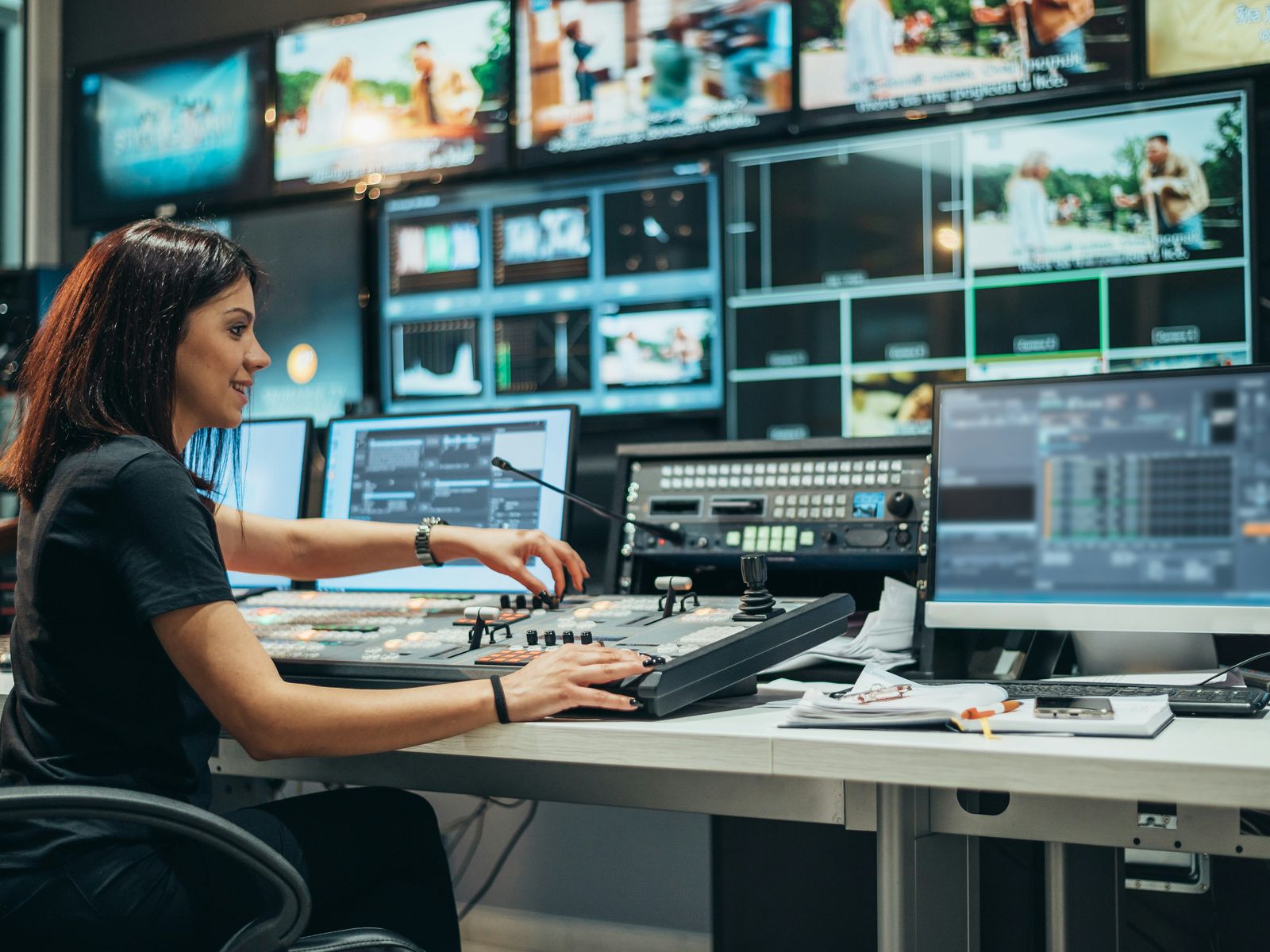 Control room with operator consoles. The glass-cockpit contrast is the point.