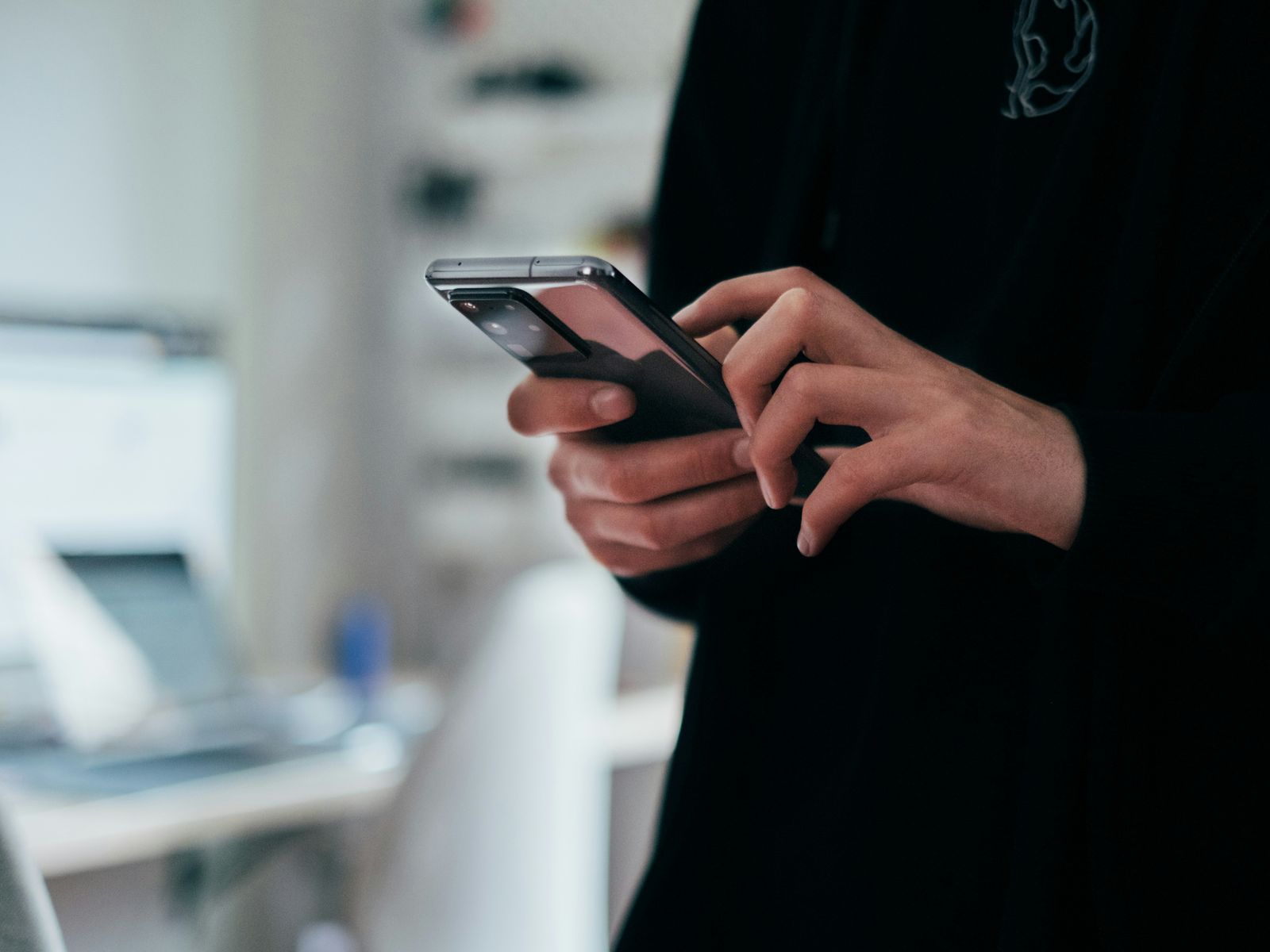 Older adult using a phone, or a clean device UI shot. Healthcare-adjacent, warm.