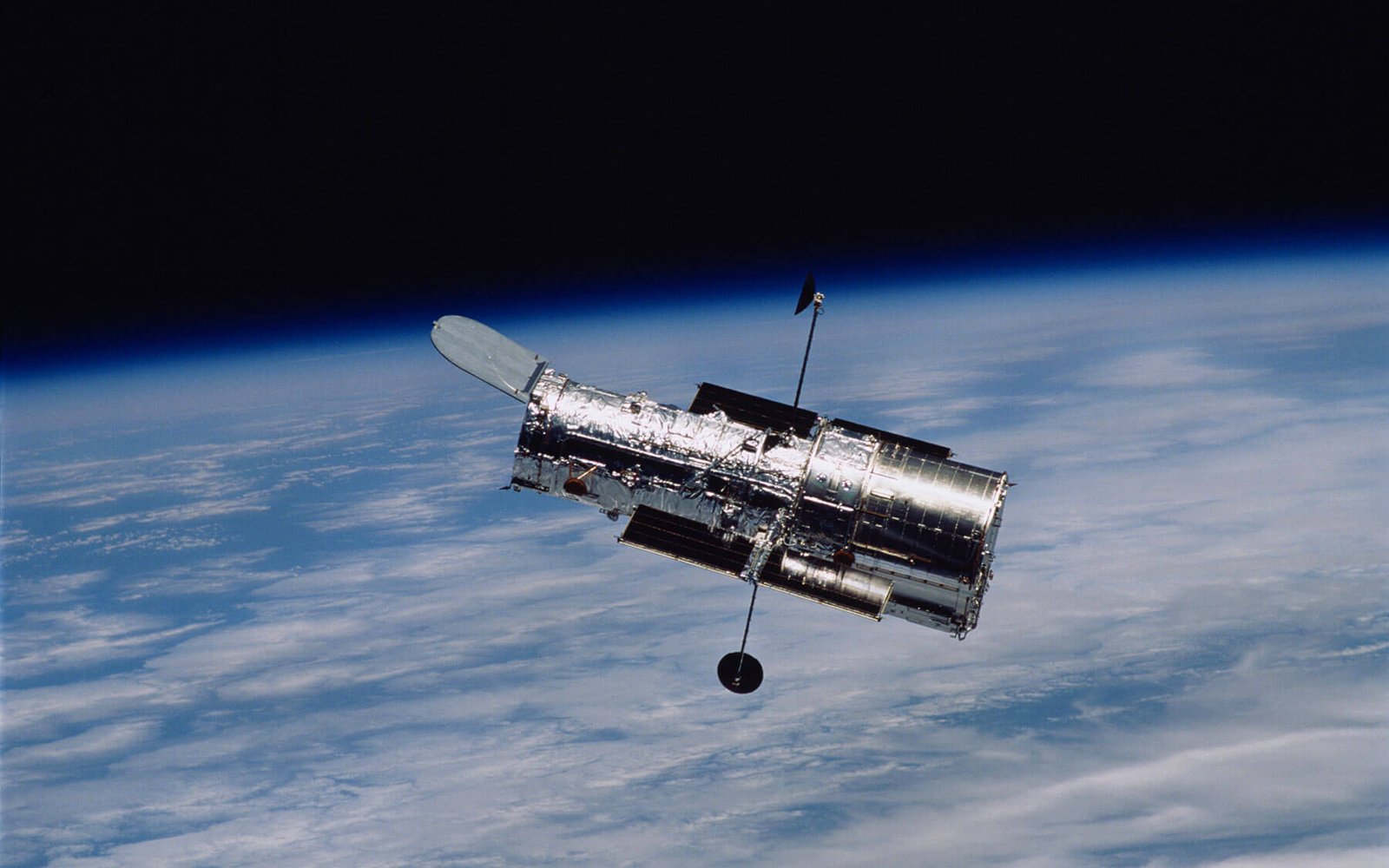 Hubble-era mission control, operators at telemetry consoles.